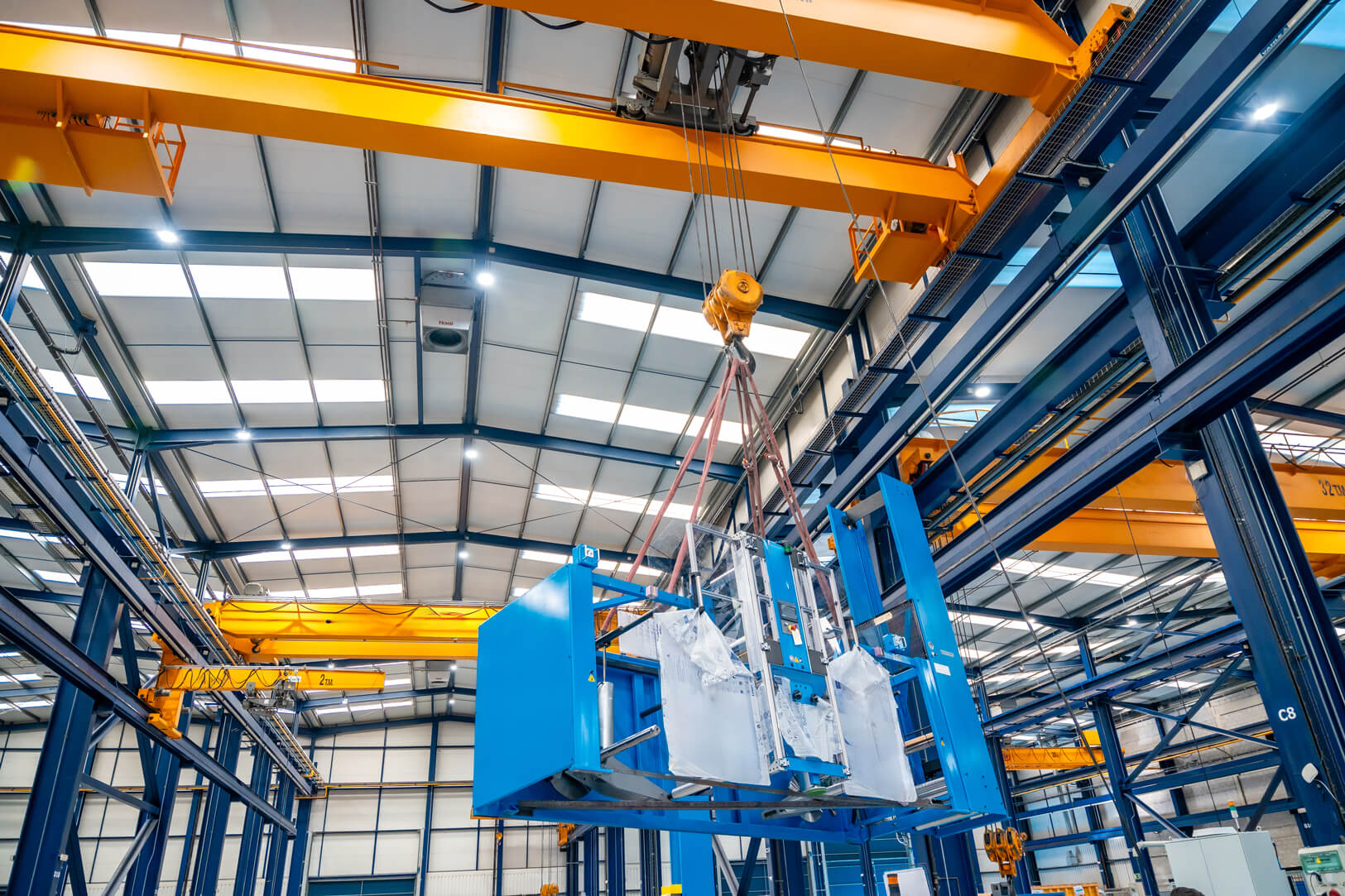 a-huge-crane-lifting-heavy-machinery-indoors (1)